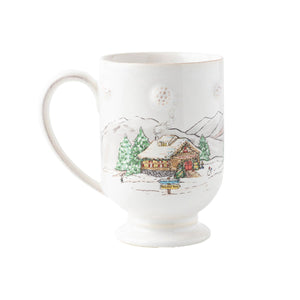 White ceramic mug from the Juliska Berry & Thread North Pole Serveware Collection featuring a painted snowy cabin scene with signs for “Santa’s Workshop” and “Reindeer Barn.”