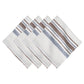 The Danish Stripe Table Linen Collection by Juliska features white napkins with blue and brown stripes, showcasing minimalist Scandinavian-inspired elegance.