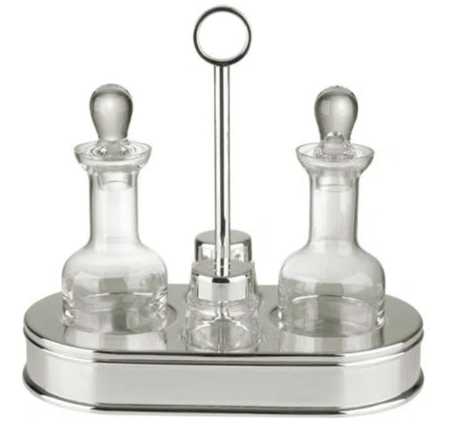 The St. James 5 Piece Oval Cruet Set includes two crystal containers with stoppers, displayed on a silver-plated tray stand with a central handle for elegant separation.