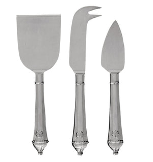 The Juliska Berry & Thread Polished Cheese Knife Set features three stainless steel knives—flat spatula, fork-tipped knife, and pointed spreader—each with ornate handles, perfect for elevating any cheese lover’s collection.