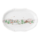 The Juliska Berry & Thread North Pole Collection features an oval ceramic platter with a winter scene—colorful houses, trees, mountains, and skaters—perfect for festive table settings or Christmas plate displays.