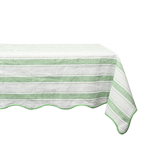 A rectangular table displays a Juliska Cabana Stripe Tablecloth, featuring a green and white striped design with elegant cabana stripes and a charming scalloped trim.
