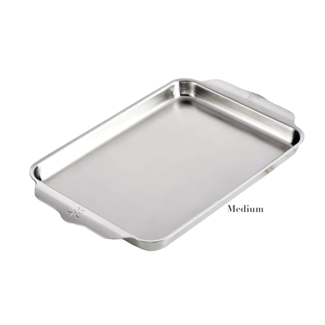 A Hestan Provisions OvenBond Sheet Pan from the Medium Collection, rectangular with raised edges and handles, crafted from triple-bonded clad stainless steel and oven safe to 600°F, shown on a white background.