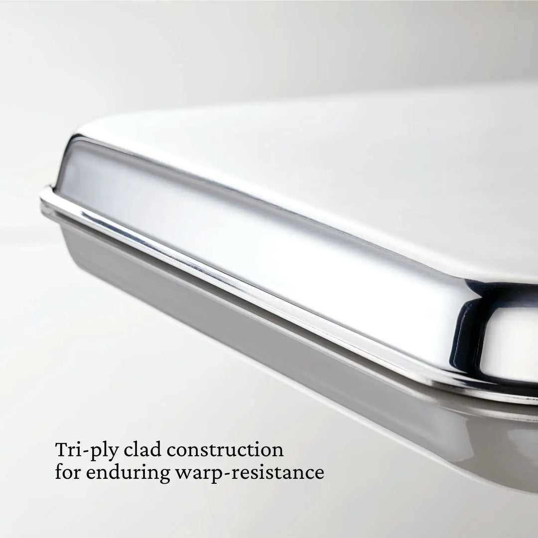 Close-up of a Hestan Provisions OvenBond Sheet Pan Collection, featuring tri-ply clad stainless steel for lasting warp resistance. Oven safe to 600°F.
