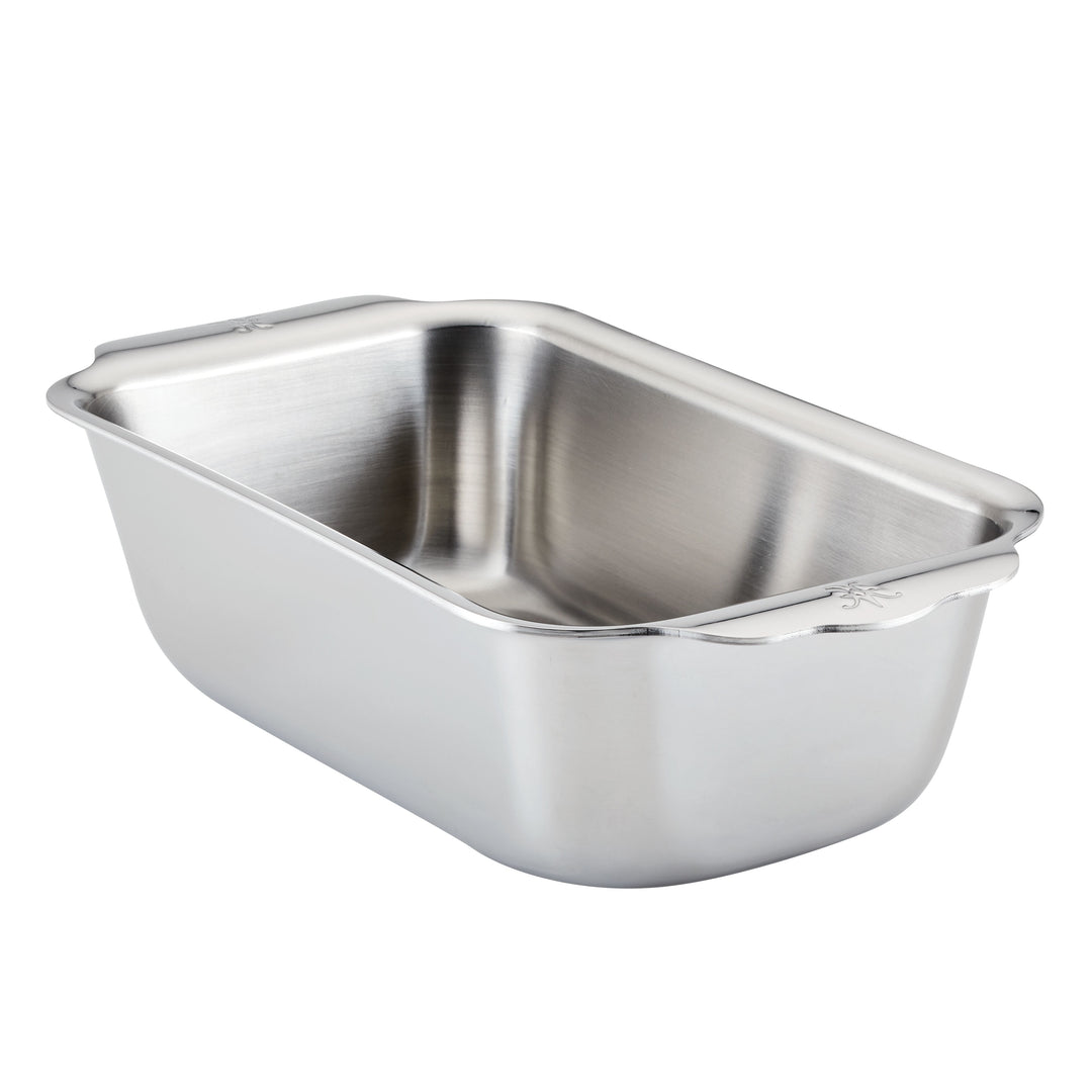 The Hestan Provisions OvenBond Tri-ply Stainless Steel Loaf Pan, featuring rounded corners and extended handles, is shown on a white background and provides excellent heat conductivity for even baking.