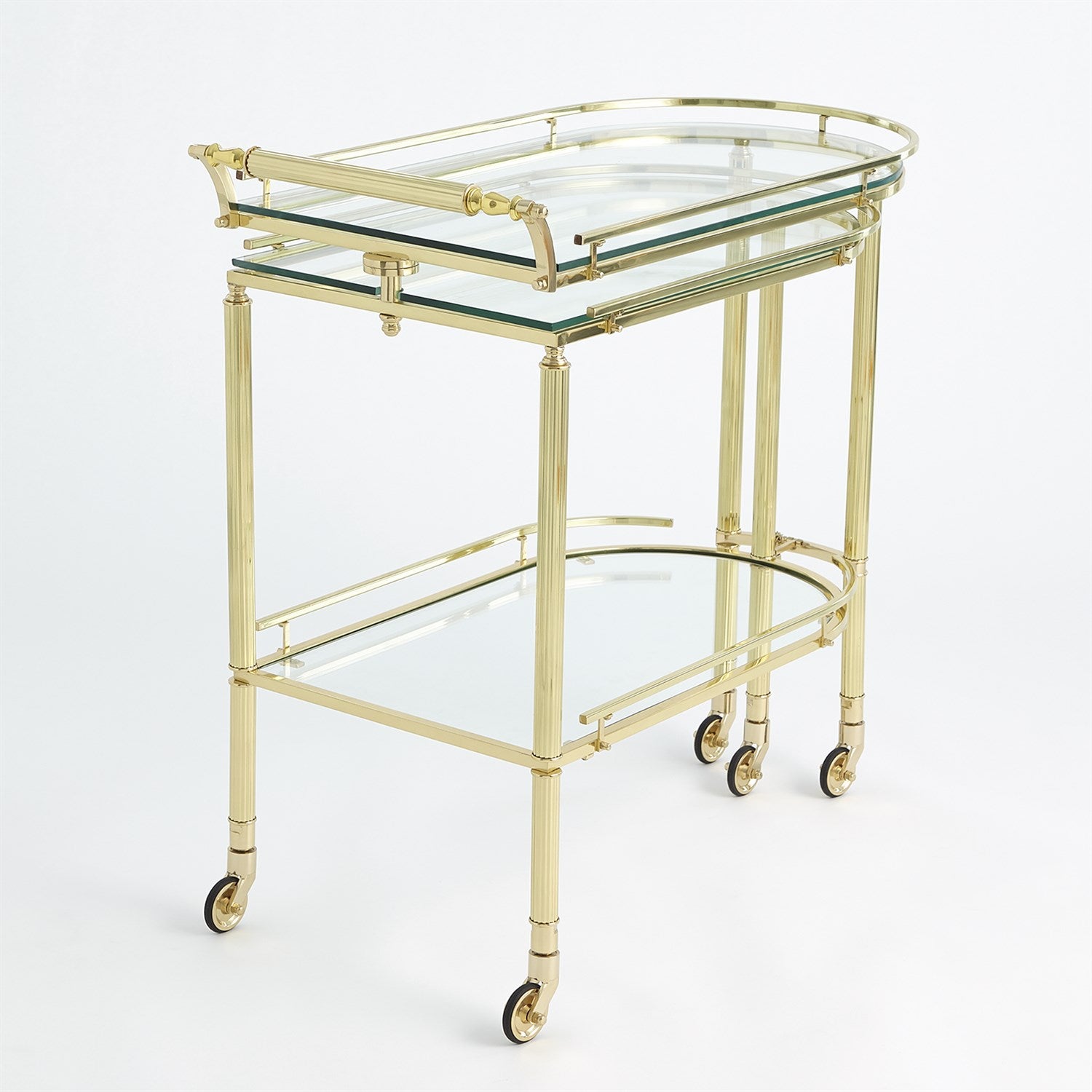The Gallery Folding Bar Shiny Brass by Global Views features solid brass construction, two glass shelves, and four small caster wheels, shown against a plain white background.