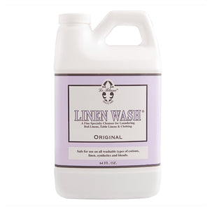A 64 fl. oz. bottle of Le Blanc's Linen Wash, a specialty cleanser for luxury linens, cottons, and synthetics with a triple-concentrated formula.