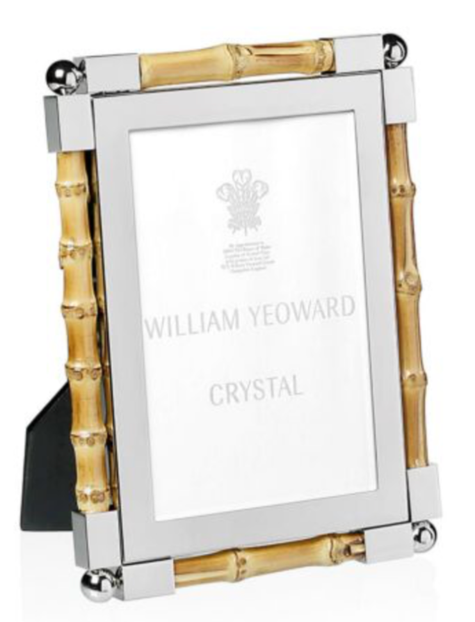 The Bamboo Classic Frame Collection by William Yeoward Crystal features a rectangular bamboo frame with nickel-plated silver and gold borders, holding a branded placeholder card—an elegant addition to your home décor.