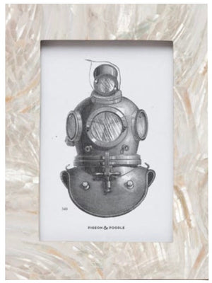 The Pigeon & Poodle Aurora Frame Collection features a framed illustration of a vintage deep-sea diving helmet set against a textured, pearl-inspired background and encased in an iridescent shell-accented frame.