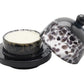 A round bar of soap sits on the Blue Pheasant Andrew Leopard Butter Dish, featuring a black base and a matching partially open black and white speckled cover crafted from durable glass.