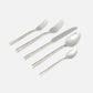 The Blue Pheasant Annella 5 Piece Flatware Set in silver features textured, hammered stainless steel handles and includes a dinner fork, salad fork, knife, soup spoon, and teaspoon, all shown on a white background.