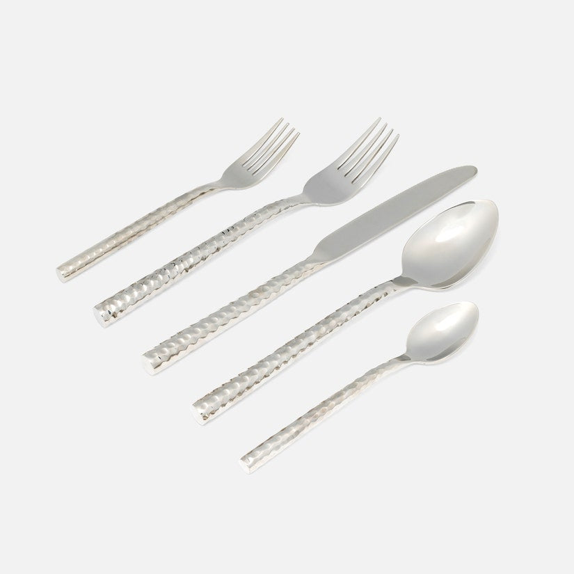 The Blue Pheasant Annella 5 Piece Flatware Set in silver features textured, hammered stainless steel handles and includes a dinner fork, salad fork, knife, soup spoon, and teaspoon, all shown on a white background.