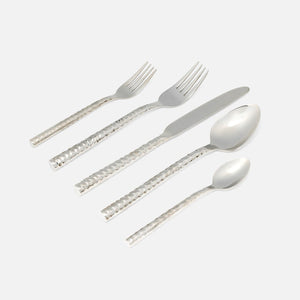 The Blue Pheasant Annella 5 Piece Flatware Set in silver features textured, hammered stainless steel handles and includes a dinner fork, salad fork, knife, soup spoon, and teaspoon, all shown on a white background.