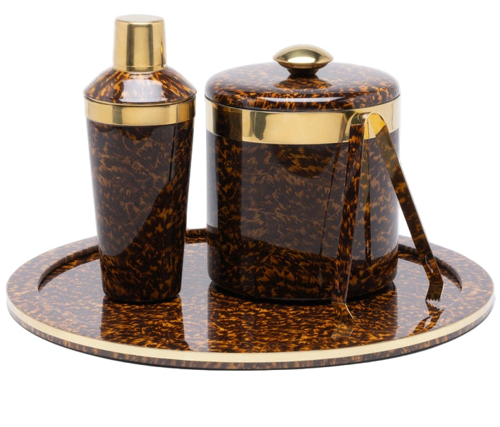 The Maximilian Bar Collection by Blue Pheasant features a brown and gold faux tortoise shell pattern with a cocktail shaker, ice bucket with lid, tongs, and round tray.