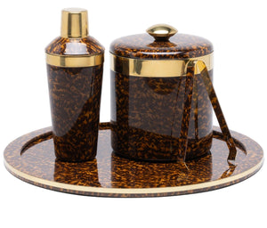 The Maximilian Bar Collection by Blue Pheasant features a brown and gold faux tortoise shell pattern with a cocktail shaker, ice bucket with lid, tongs, and round tray.