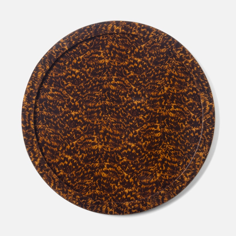 The Maximilian Bar Collection round tray by Blue Pheasant features a brown and black faux tortoise shell pattern—ideal for serving vintage barware or displaying your favorite cocktail shaker on a white backdrop.