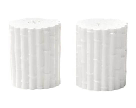 Two cylindrical, porcelain objects that resemble tree stumps are set against a plain backdrop, evoking the bamboo-inspired Blue Pheasant Daphne Salt and Pepper Shaker Set.