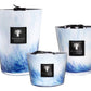 Three Baobab Eden Seaside candles from the Baobab Collection, each featuring a unique blue and white marbled pattern with black labels, fill the air with the calming scent of vetiver.