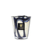 A Baobab Stones Lazuli candle in a glass holder with blue and white swirling patterns, isolated on a white background.
