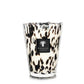 A Baobab Pearls Black Candle from the Baobab Collection in a hand-blown glass holder with a black and white animal print design.