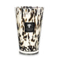 Decorative Baobab Collection Pearls Black Candle in a hand-blown glass holder with a tortoiseshell pattern and the label "Baobab Collection.