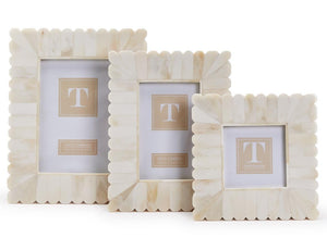 The Bone Scalloped Frame Collection by Two's Company features three cream-colored decorative frames with scalloped edges, displayed upright side by side against a plain white background.