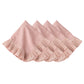 The Juliska Mademoiselle Napkin Set includes four light pink napkins with knife-pleat ruffle borders, neatly folded in a row—ideal for adding romance to your tablescape.