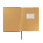 The Juliska Naughty/Nice Embossed Journal features an open ruby red cover, a blank "Belongs To" label on the right page, and a red ribbon bookmark draped down the center.