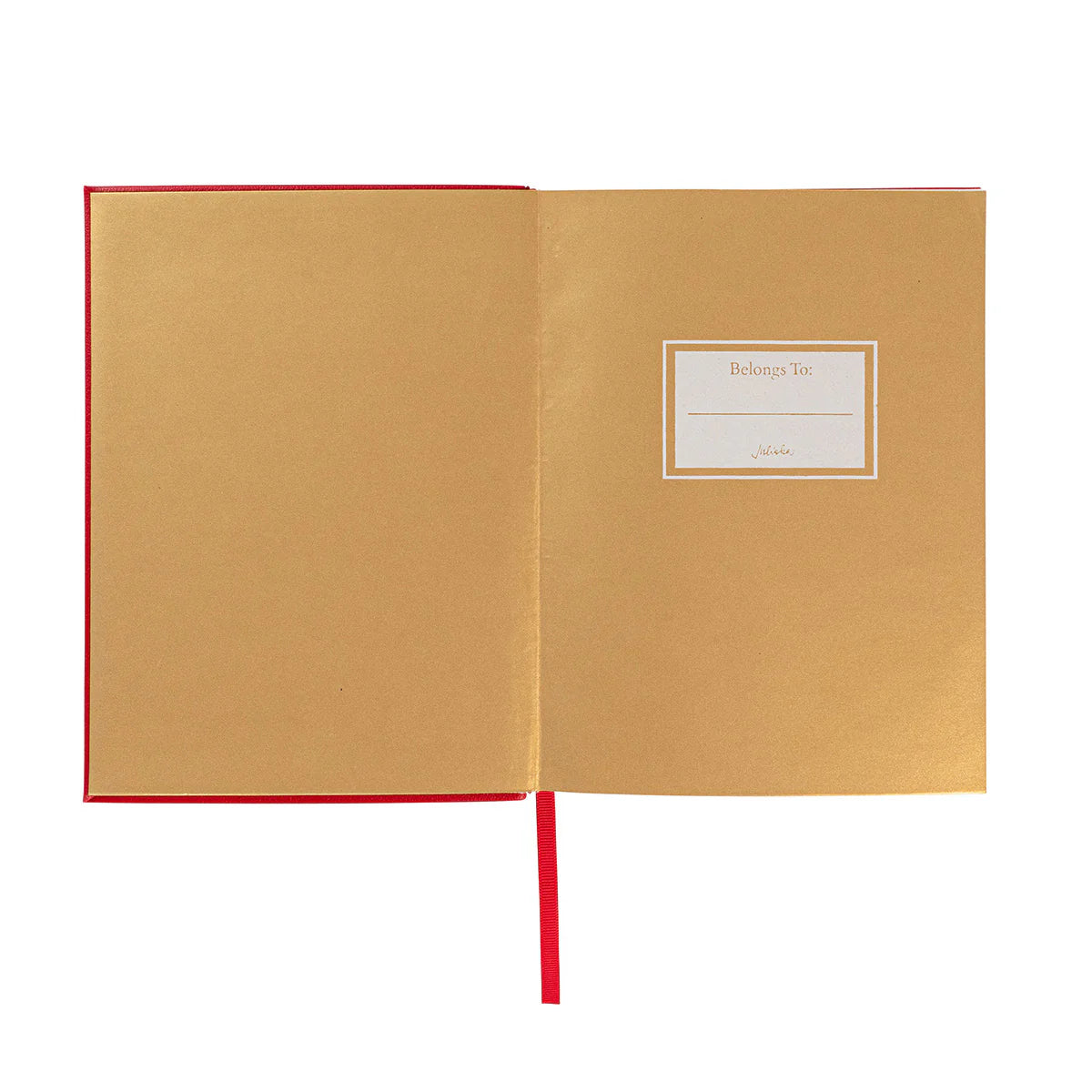 The Juliska Naughty/Nice Embossed Journal features an open ruby red cover, a blank "Belongs To" label on the right page, and a red ribbon bookmark draped down the center.