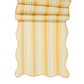 The Juliska Cabana Stripe Tabletop Collection features yellow and white cabana striped fabric with scalloped trim, partially folded at the top.