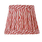 The Zafferano x Fermoie Poldina Lampshade Collection by Zafferano America features hand-made lampshades with red and white wavy stripes, adding a stylish accent to any room.