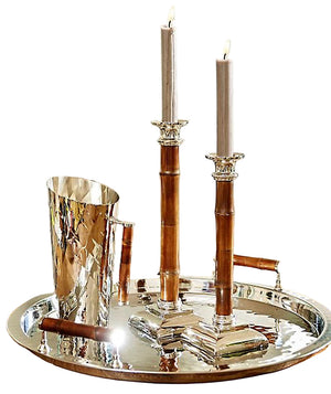 The ezrad Bamboo and Stainless Steel Decor Collection features a silver tray showcasing modern elegance with two bamboo candle holders and a hammered stainless steel pitcher with a wooden handle, all stylishly arranged.