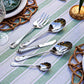 The Juliska Berry & Thread Polished Hostess Serving Set features five stainless steel pieces—spoons, a fork, and a knife—elegantly arranged, making it an ideal hostess gift or the perfect addition to your tableware collection.