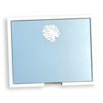 A rectangular light blue card from the Large Blue Note Pad Collection by Black Ink, featuring a white monstera leaf at the top center and a white border.