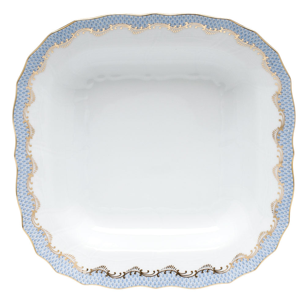 The Herend Fish Scale Square Fruit Dish, Light Blue, features scalloped edges and a white center with hand-painted blue and gold trim, offering artistic appreciation similar to classic Herend porcelain.
