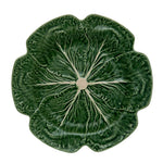 A green ceramic plate from the Green Cabbage Dinnerware Collection by Bordallo Pinheiro, crafted in Portugal with detailed veins and stem to resemble a cabbage leaf.