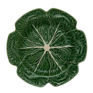 A green ceramic plate from the Green Cabbage Dinnerware Collection by Bordallo Pinheiro, crafted in Portugal with detailed veins and stem to resemble a cabbage leaf.