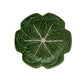 A plate from the Green Cabbage Dinnerware Collection by Bordallo Pinheiro, featuring a leafy cabbage design in green ceramic, is shown from above on a white background.