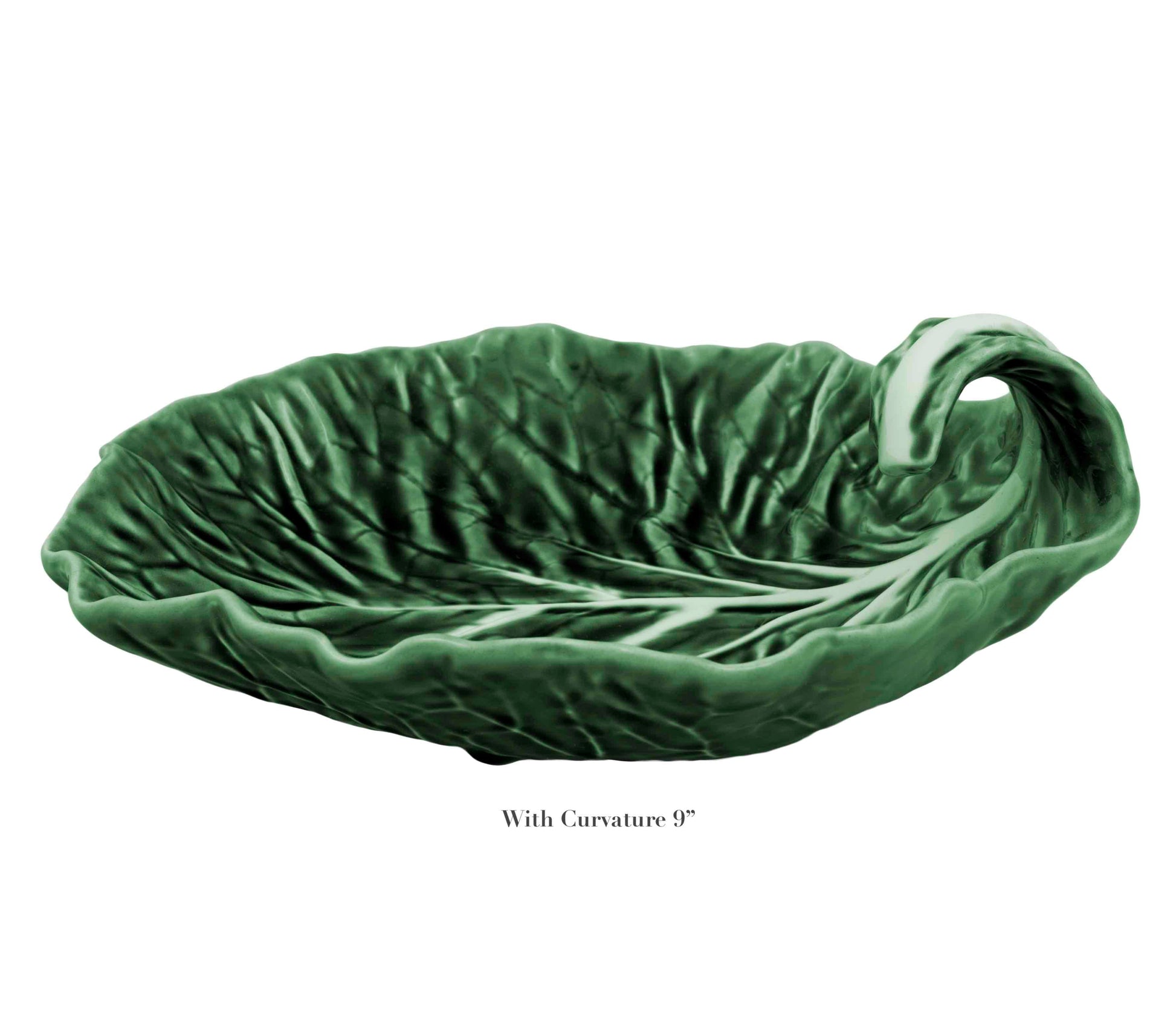 A green ceramic handmade dish from HIVE’s Cabbage Leaf Green Collection, shaped like a leaf with curled stem handle and visible veins, labeled “With Curvature 9°.” Part of our Serveware Collection.