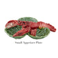 This Bordallo Pinheiro ceramic appetizer plate showcases a red lobster on a vivid green leaf backdrop, embodying the spirit of the Cabbage with Lobsters Serveware Collection.