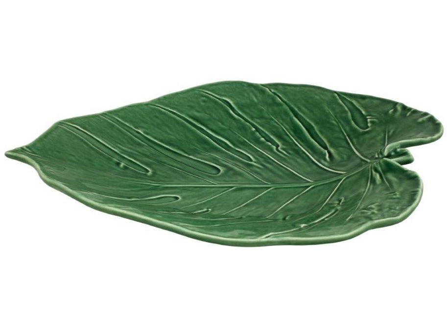 The Swiss Cheese Leaf Platter by HIVE is a green ceramic platter handmade in Portugal, featuring leaf-shaped design with detailed veining and a glossy finish.