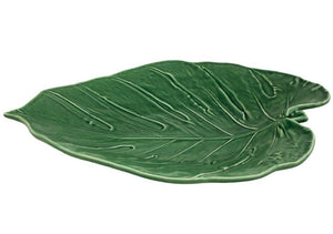 The Swiss Cheese Leaf Platter by HIVE is a green ceramic platter handmade in Portugal, featuring leaf-shaped design with detailed veining and a glossy finish.