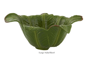 Large green ceramic salad bowl, shaped like overlapping lettuce leaves, from the Bananas From Madeira Serveware Collection by Bordallo Pinheiro. Shown on a white background, with “Large Salad Bowl” text beneath.