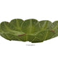 The Bananas From Madeira Serveware Collection by Bordallo Pinheiro features a green ceramic bowl shaped like overlapping lettuce leaves, labeled "Centerpiece" below, ideal for adding a tropical vibe to your table.