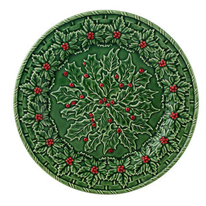 The Hive Holly Serveware Collection features handmade earthenware plates with raised holly leaf and berry wreath designs—ideal for festive holiday table decor.
