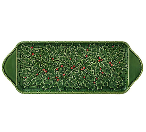 The Hive Holly Serveware Collection features a green rectangular serving tray with raised holly leaves, red berry accents, and handles—ideal as festive holiday table décor or a handmade earthenware plate for gatherings.