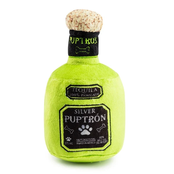 The Puptron Tequila Dog Toy from Haute Diggity Dog is a green plush dog toy shaped like a tequila bottle, featuring the words “Puptron” and “Silver” on the label. It’s part of the playful Muttini Bar & Grill Collection.