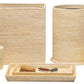 The Dalton Bath Collection by Pigeon & Poodle features handmade woven beige rattan accessories, including a tissue box, soap dispenser, waste bin, toothbrush holder, lidded container, and tray with grooming tools.