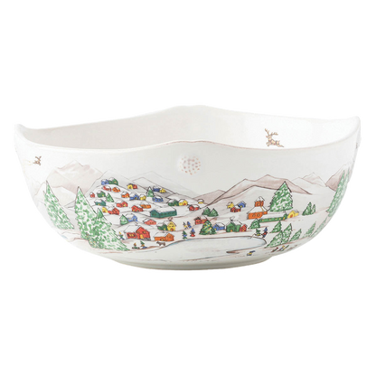 The Berry & Thread North Pole Dinnerware and Serveware Collection by Juliska features a white ceramic bowl with hand-painted village scenes—houses, trees, mountains, and a pond—ideal for holiday layering or pairing with reindeer Christmas tableware.
