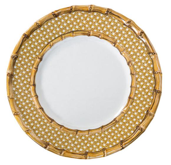 The Juliska Bamboo Caning Melamine Dinnerware Collection features a round plate with a white center, bamboo border, and gold lattice, crafted from shatterproof melamine for durability and elegance.